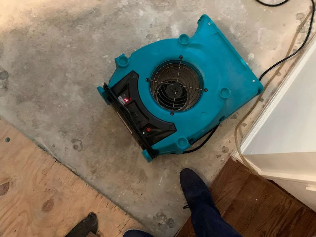 Air mover drying subfloor during Commercial Water Damage Restoration in Perris